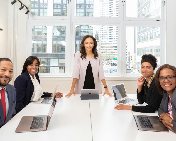 pexels photo 1367272 1367272 Multicultural team collaborating in boardroom with laptops, showcasing teamwork and diversity.